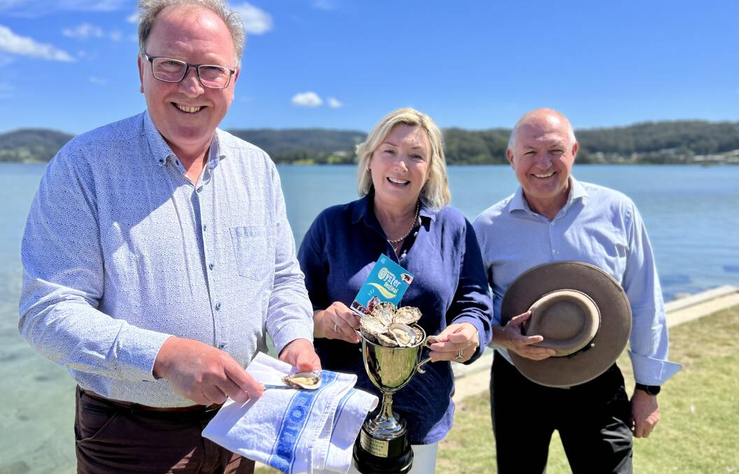 Bega member Dr Michael Holland and Cath Peachey, chair of Narooma Rocks, enjoy some freshly shucked oysters as shadow minister for jobs, investment and tourism watches. Picture by Narooma Rocks.