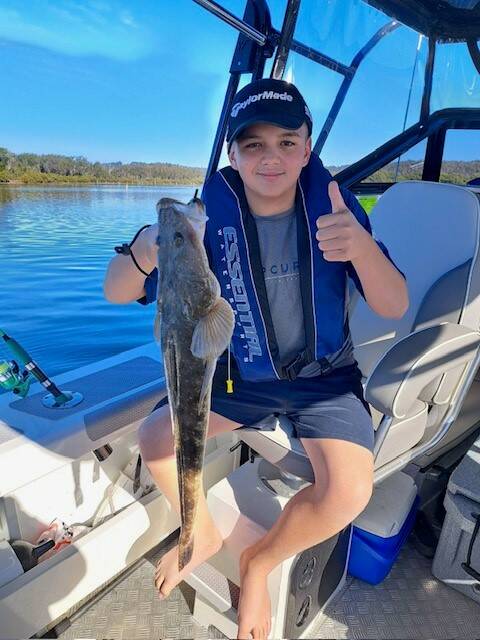Young Ryan Bissett from Canberra with his personal best dusky flathead that he caught during the school holidays.