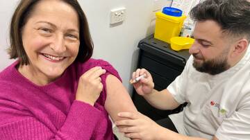 Member for Gilmore Fiona Phillips popped into Priceline Pharmacy in Nowra where she was given her flu shot by owner pharmacist Ali Bazzi. Picture supplied.