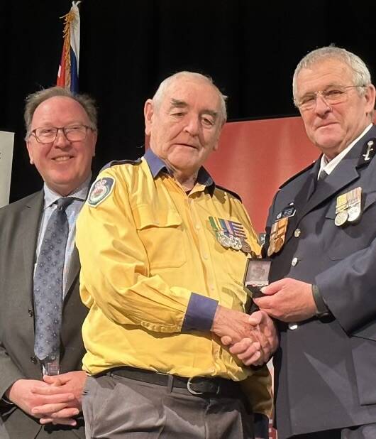 Brian Ayliffe is thanked for 66 years in the RFS by Bega MP Michael Holland and Acting RFS South Eastern Area Commander Paul Jones. Picture supplied