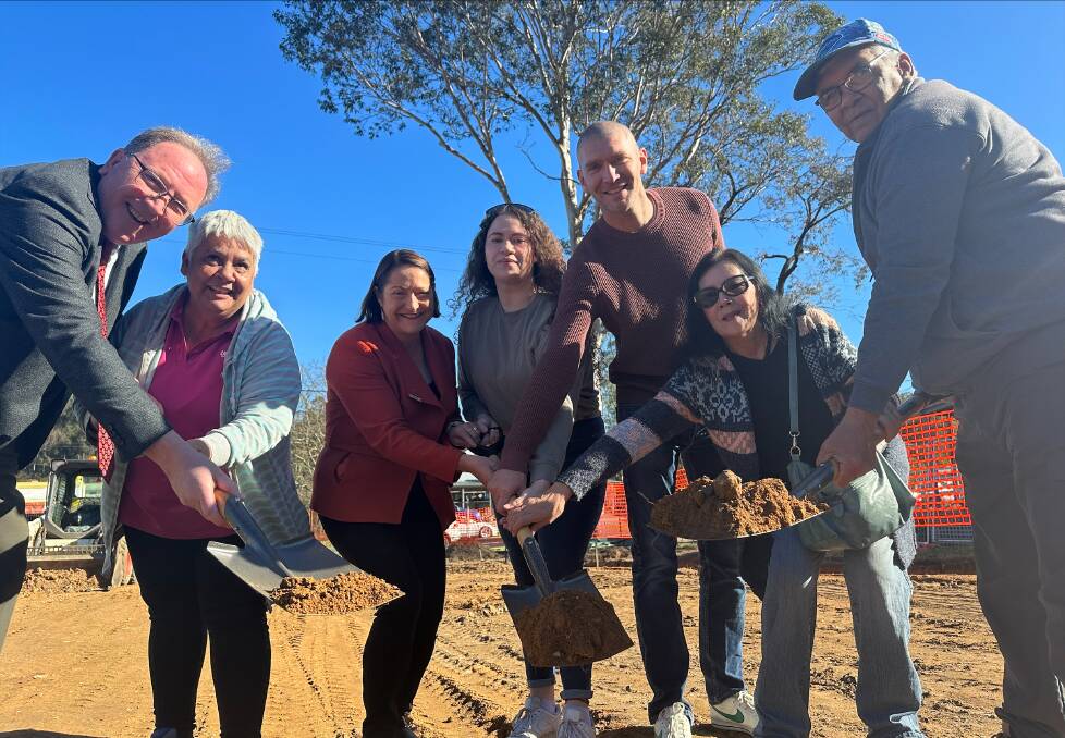 Government guests Bega MP Dr Michael Holland, Gilmore MP Fiona Phillips and Eurobodalla Shire Mayor Mat Hatcher join Tayla Nye, Aunty Linda Carlson, Uncle Sam Nye and Aunty Mary-Anne Nye to turn the first sod on the Mogo Local Aboriginal Land Council rebuild.