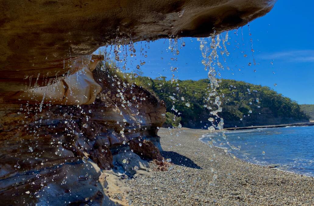Fresh water cascades over a sandstone overhang just south of Pebbly Beach. Picture by Tim the Yowie Man