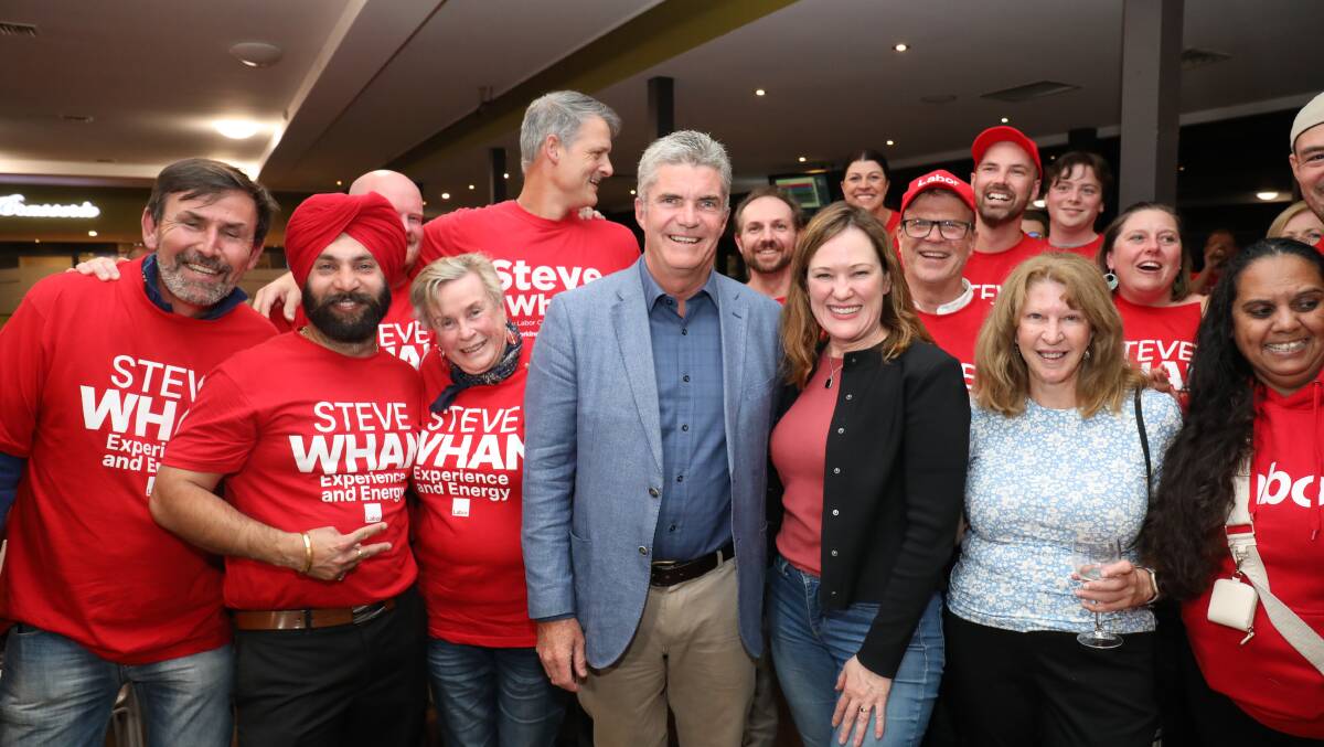 Steve Whan with supporters at the Queanbeyan Bowling Club on Saturday night. Picture by James Croucher