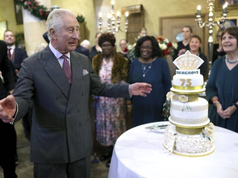 King Charles was cheered on as he cut into his three tier birthday cake at his Highgrove home. (AP PHOTO)