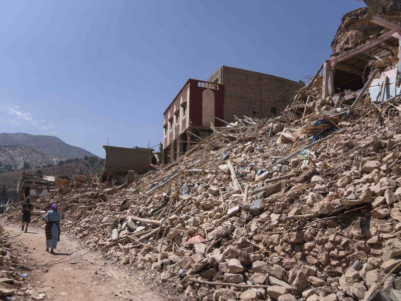 People walk amid the wreckage caused by the earthquake in the town of Imi N'tala near Marrakech. (AP)