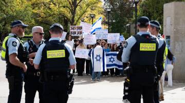 A pro-Israel rally at the ANU. Police are between the two groups. Picture by Elesa Kurtz